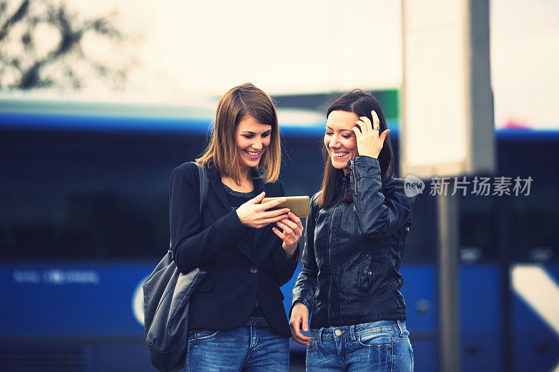 Young women waiting on the bus station